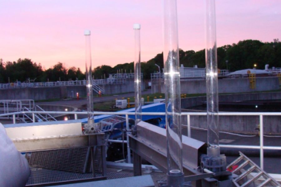 Branford WWTF weir gates with stainless gate stems and operators at dusk