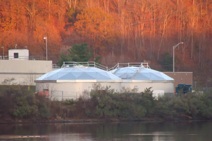 The two Lake Saltonstall finished-water tanks with aluminum geodesic dome roofs, autumn foliage behind