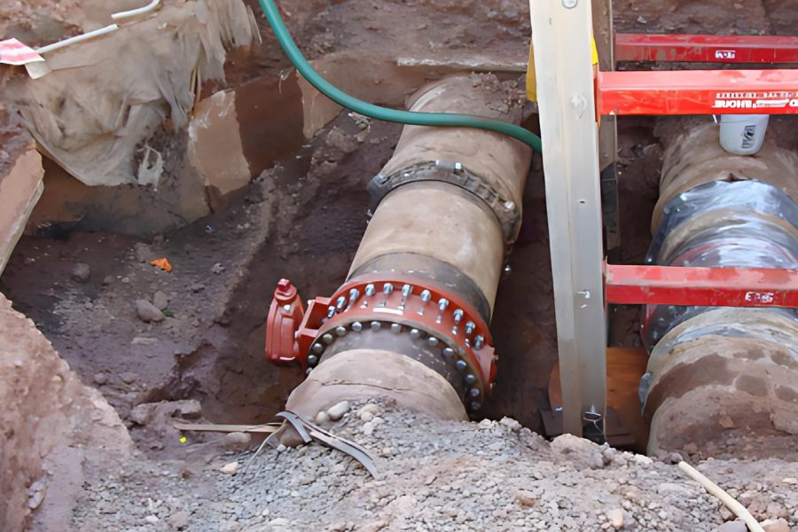 Excavated tank piping with a new red gate valve and coupling