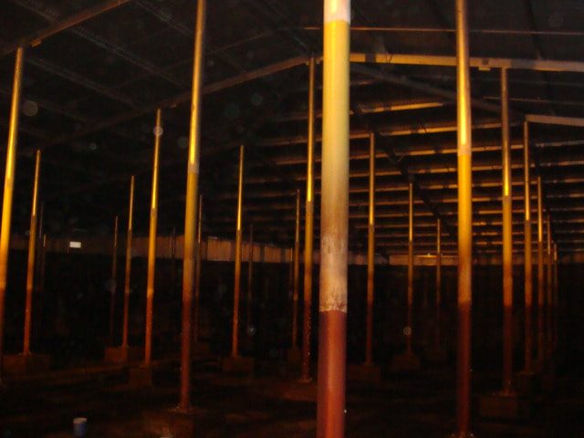 Inside the covered basin: rows of steel columns supporting the roof framing