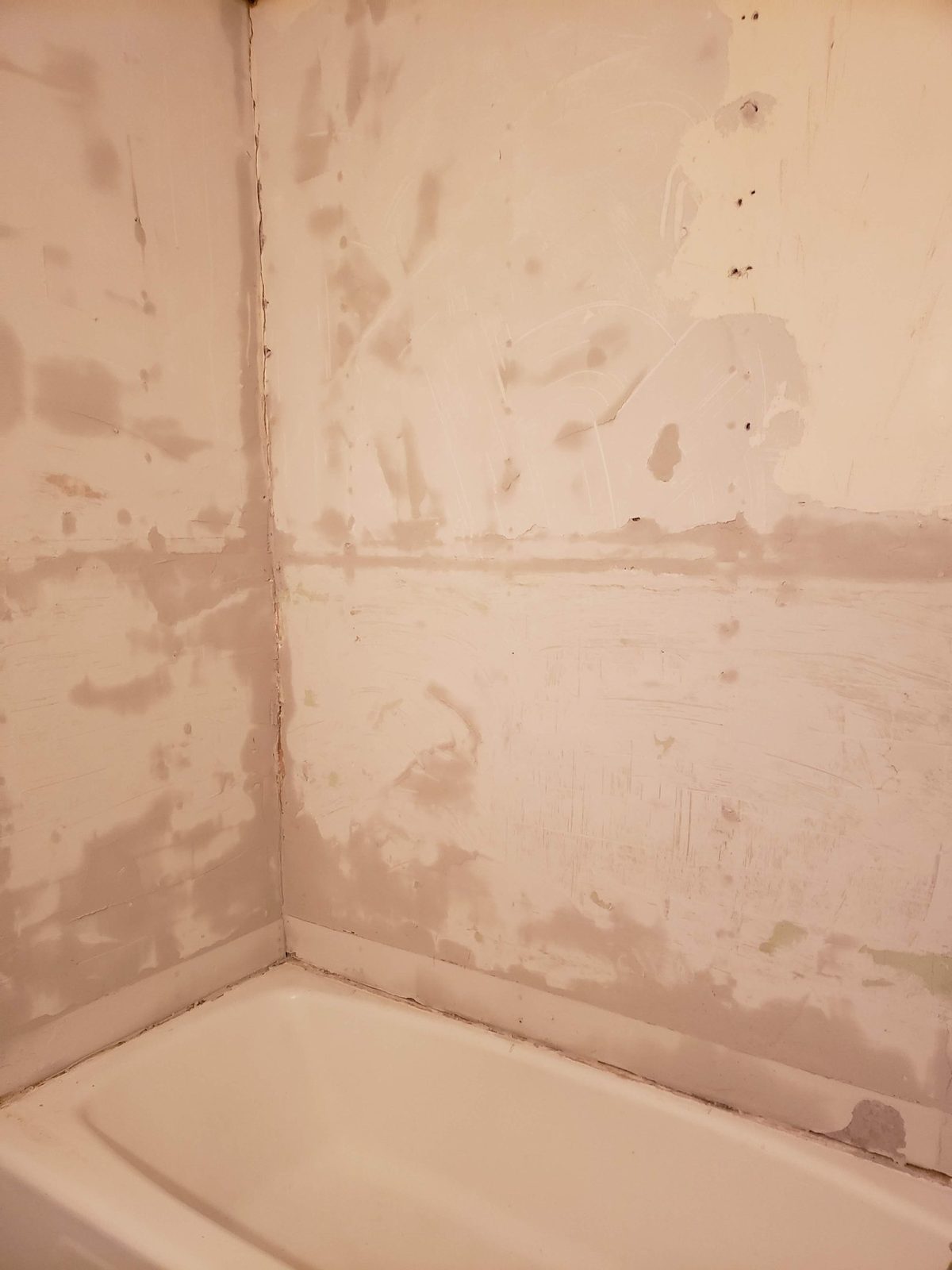 Tub surround walls patched and prepped for new tile