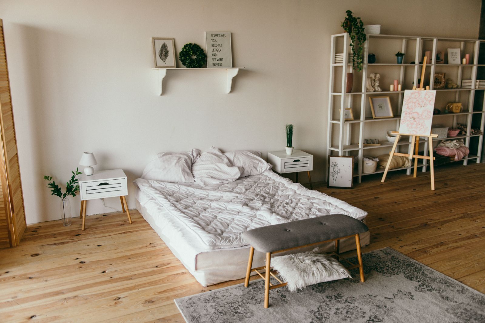 Bedroom with built-in shelving and wide-plank floors