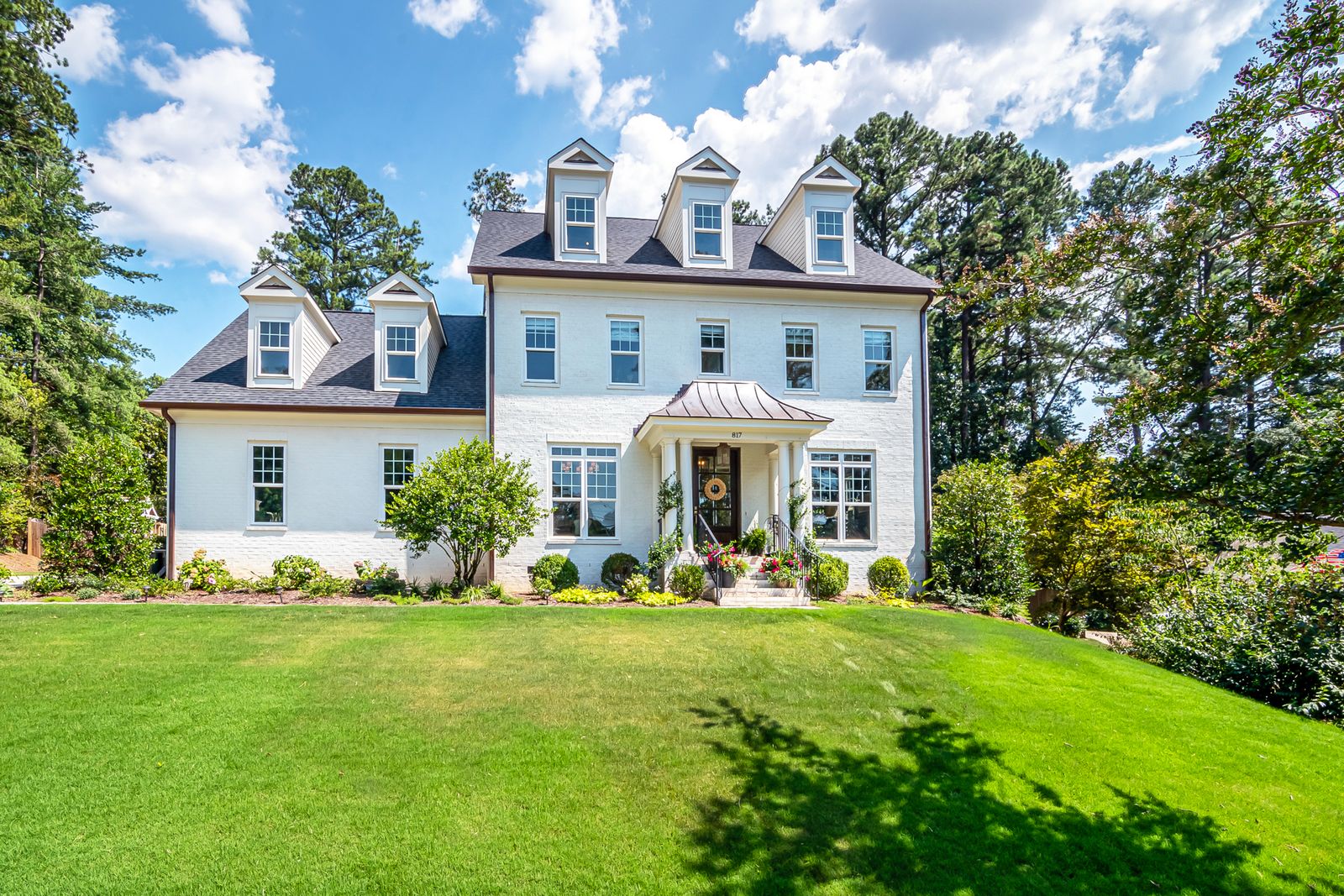 Colonial-style custom home with mature lawn